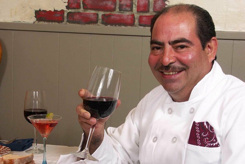 Chef holding a glass of red wine