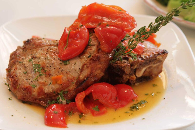 Steak entree topped with cherry tomatoes