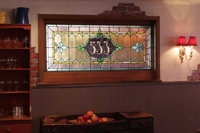 Dining room with stain glass that says 533